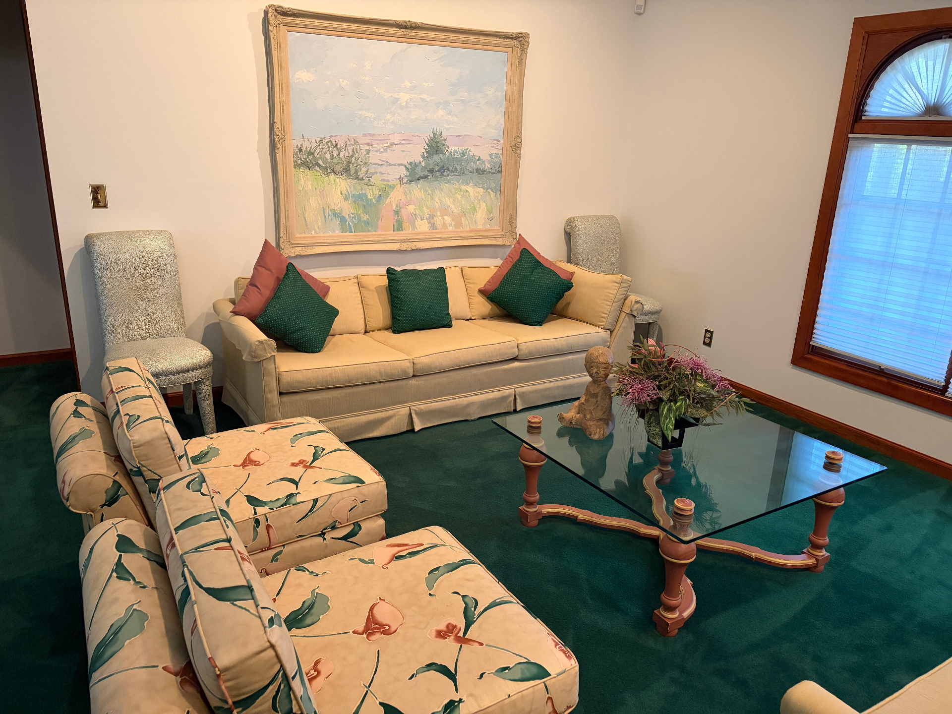 Estate cleanout living room with sofas, chairs, and artwork ready for removal in South Florida